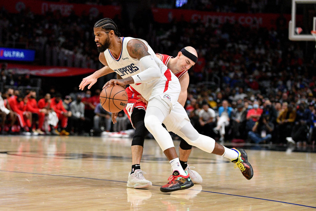 Paul George #13 of the LA Clippers dribbles the ball against Alex Caruso #6 of the Chicago Bulls during the second half at Staples Center on November 14, 2021 in Los Angeles, California.