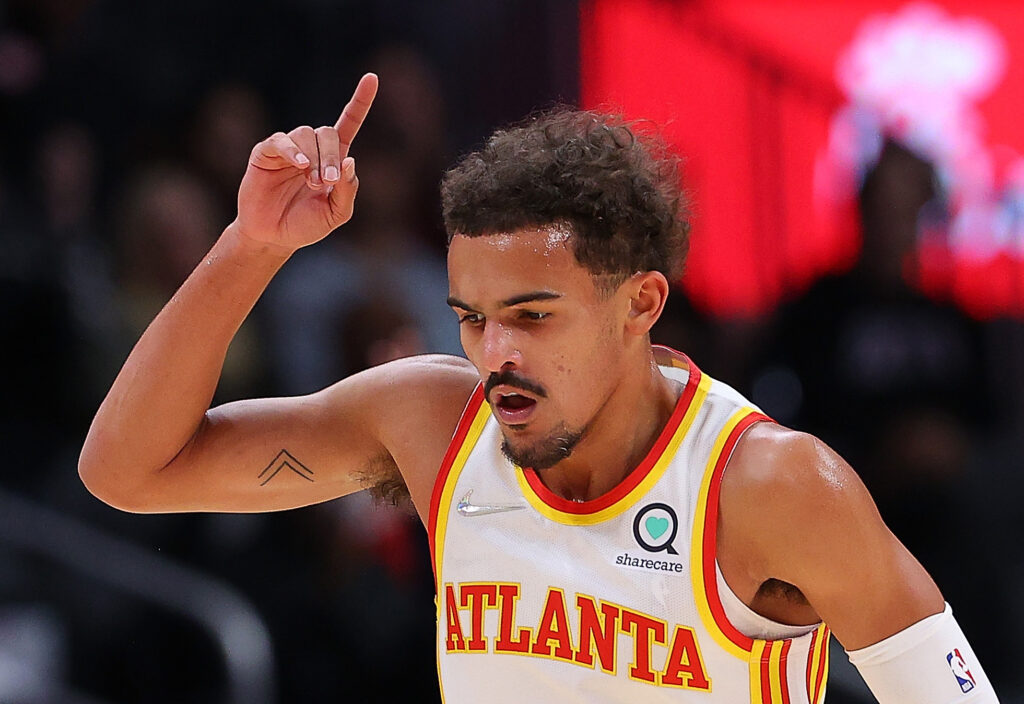 Trae Young #11 of the Atlanta Hawks reacts after hitting a three-point basket against the Oklahoma City Thunder during the first half at State Farm Arena on November 22, 2021 in Atlanta, Georgia.